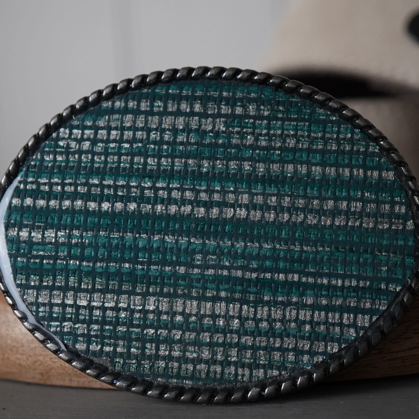 Close-up of a textured oval object on a wooden surface with a blurred background