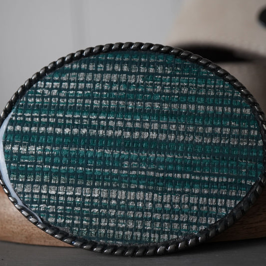 Close-up of a textured oval object on a wooden surface with a blurred background